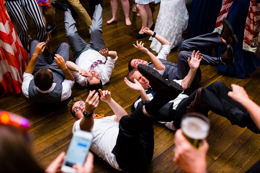 Fun wedding laying on dance floor.