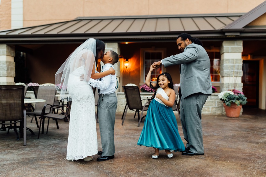 Wedding children dancing with mom and dad.